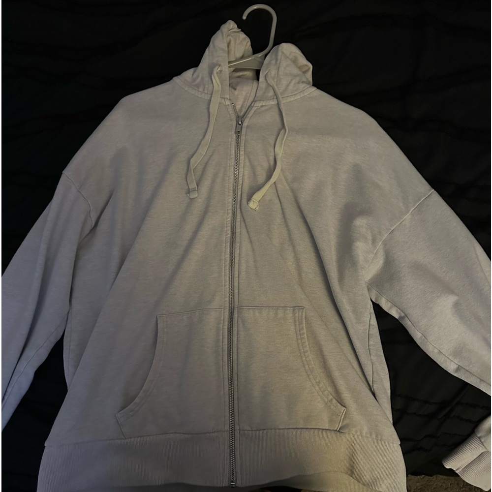 It is a large zip up jacket in a cream color